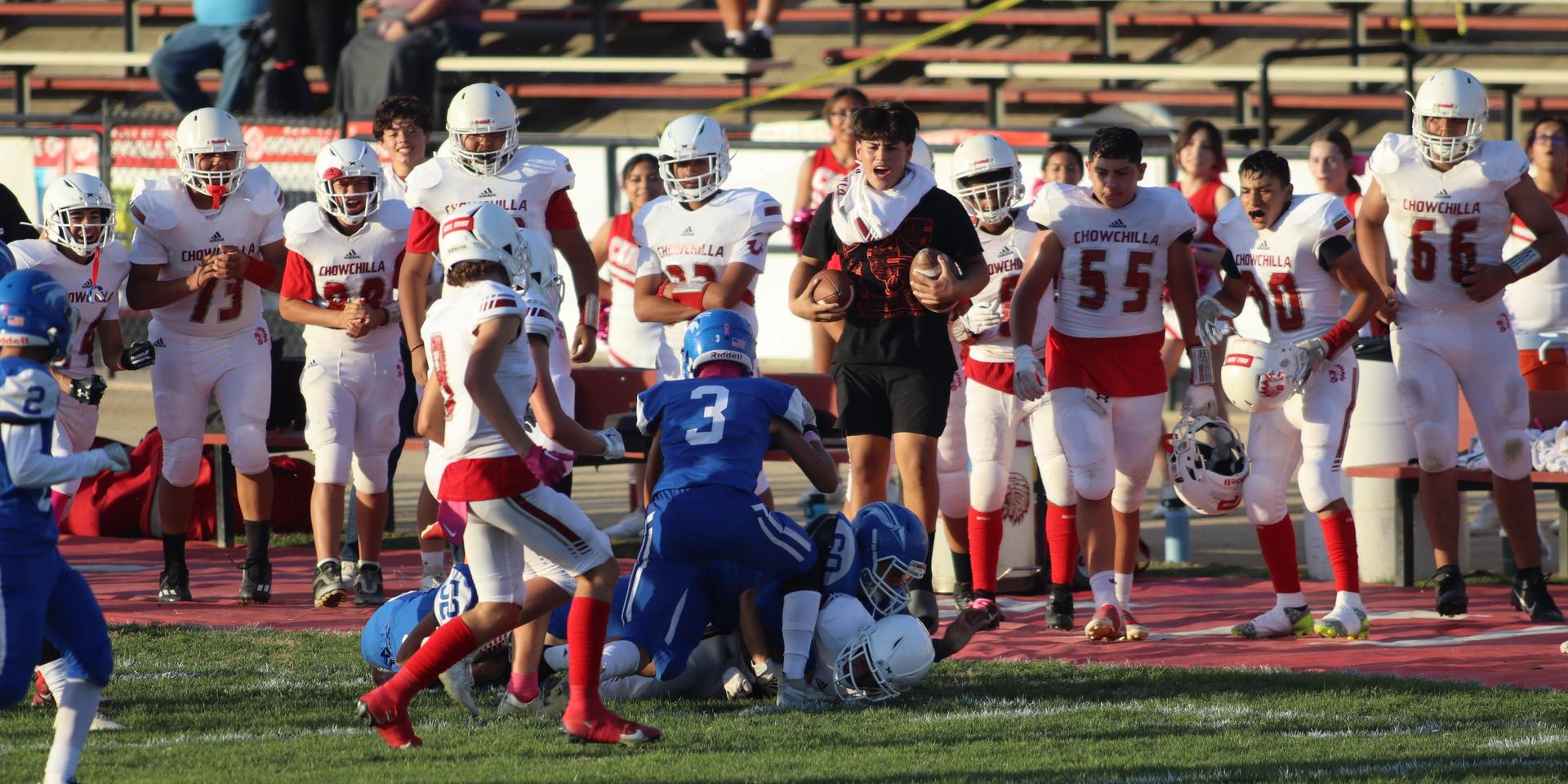 Junior Varsity football players in action against Caruthers