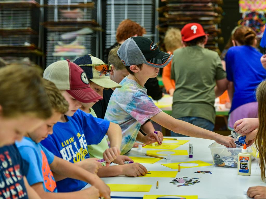 Students at a table doing a craft for Earth Day.
