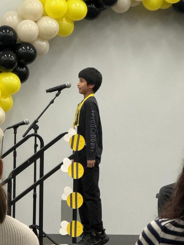 student at microphone during spelling bee
