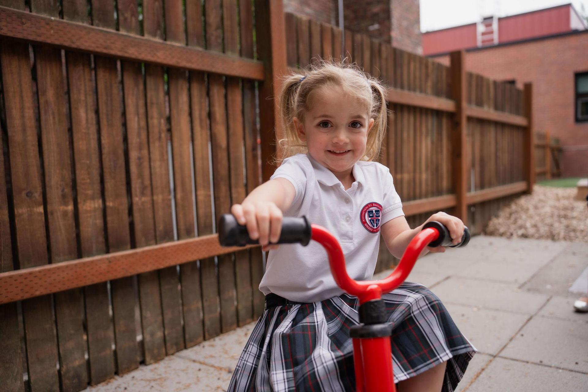 PreK student on tricycle 