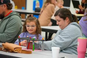 Mother and student working together to building a chair during Bennett Family STEM Night.