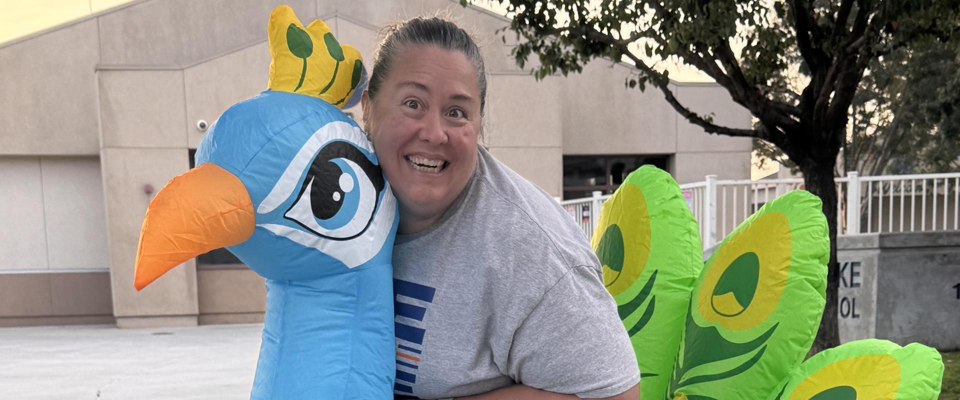 Person in a large inflatable peacock costume.