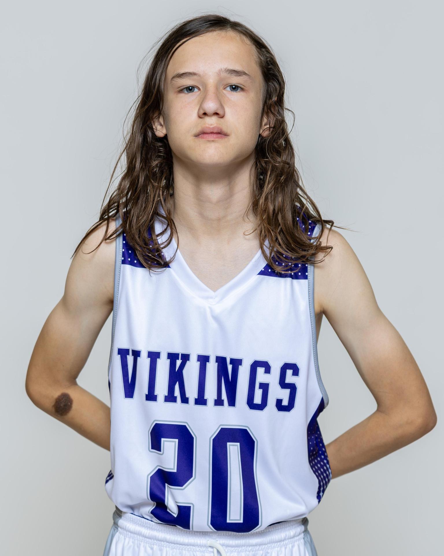 Male player number 20 posing with serious stature for a picture