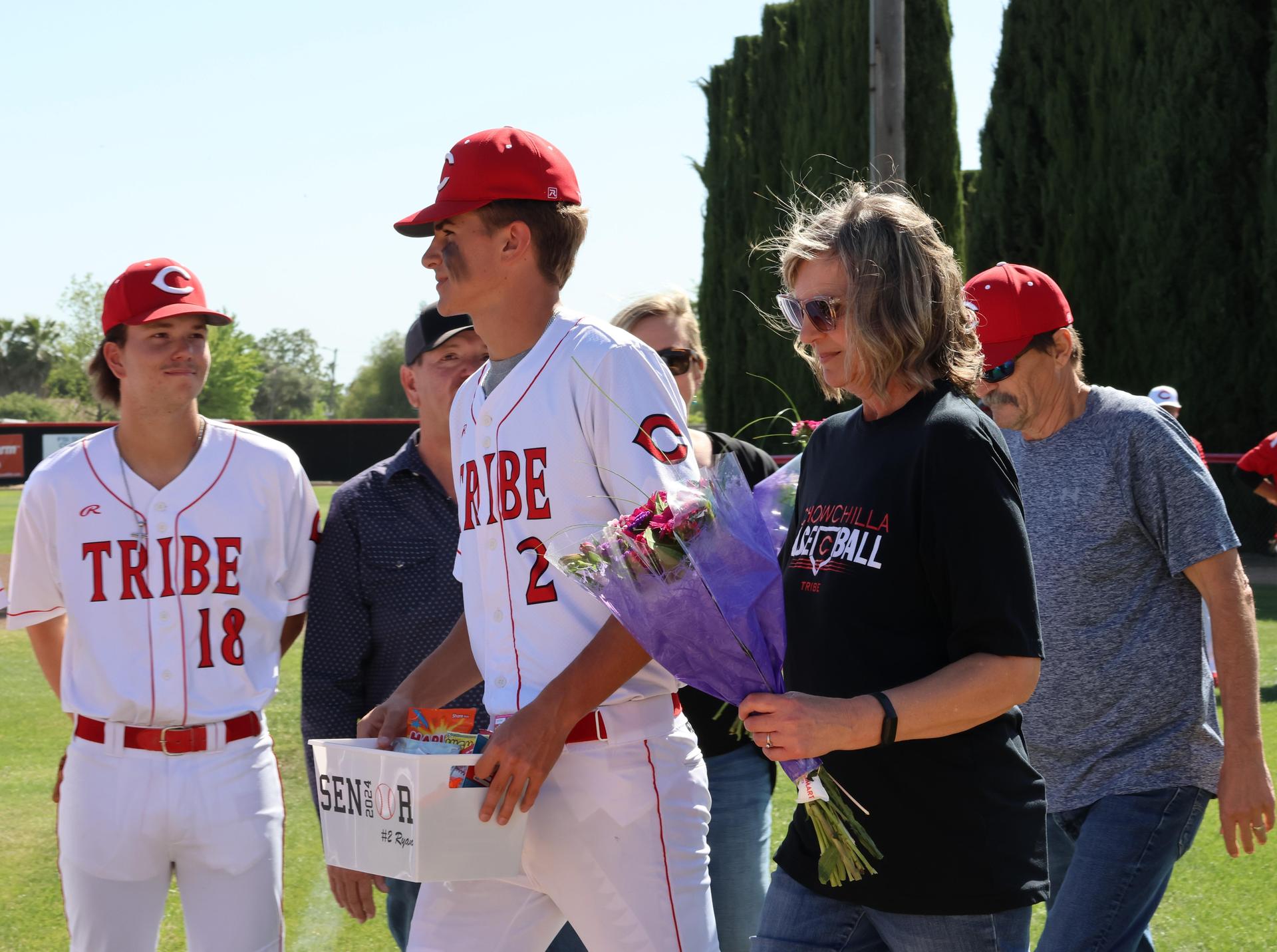 Seniors Posing With Teammates, Coaches, And Family