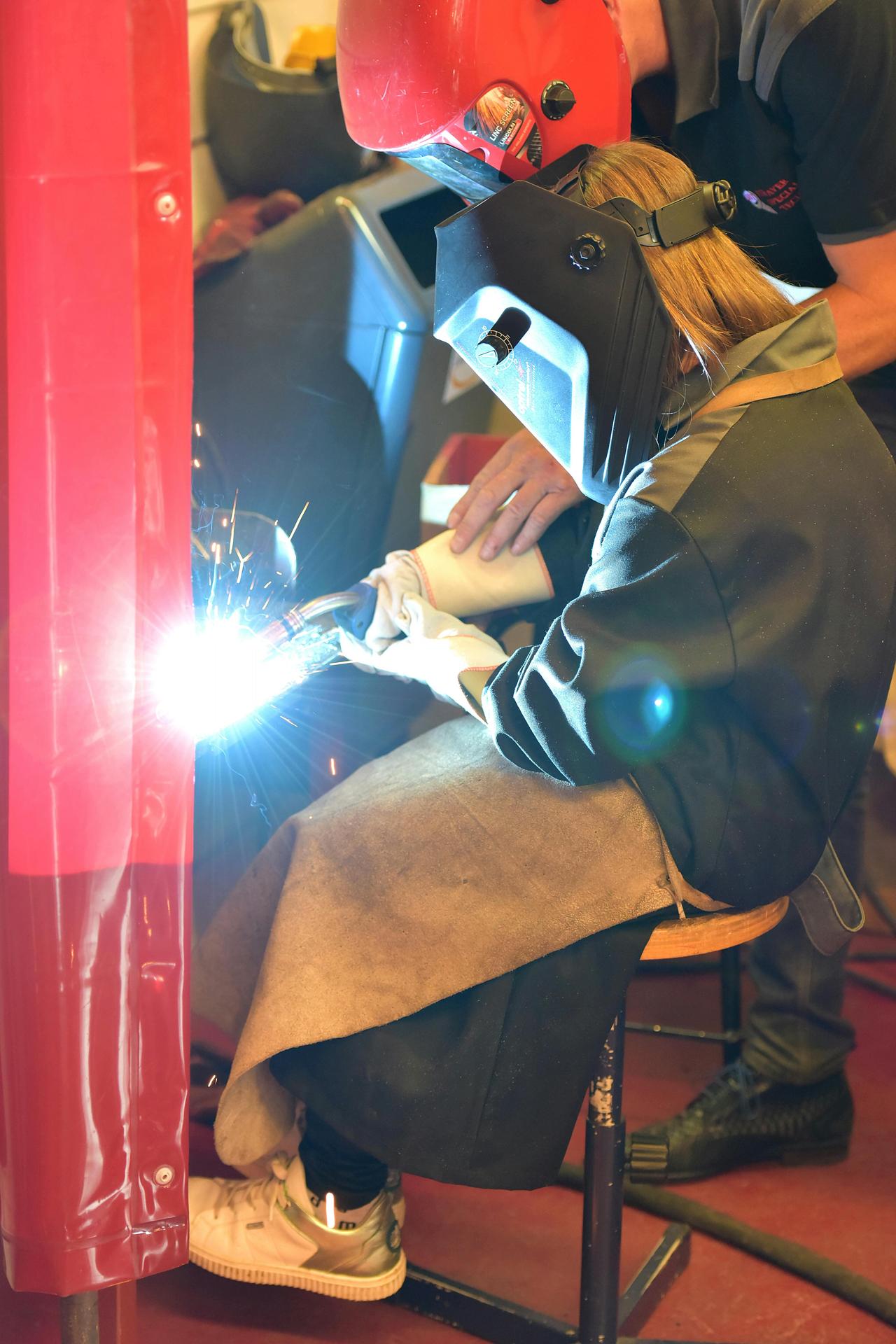 Woman with a welding helmet