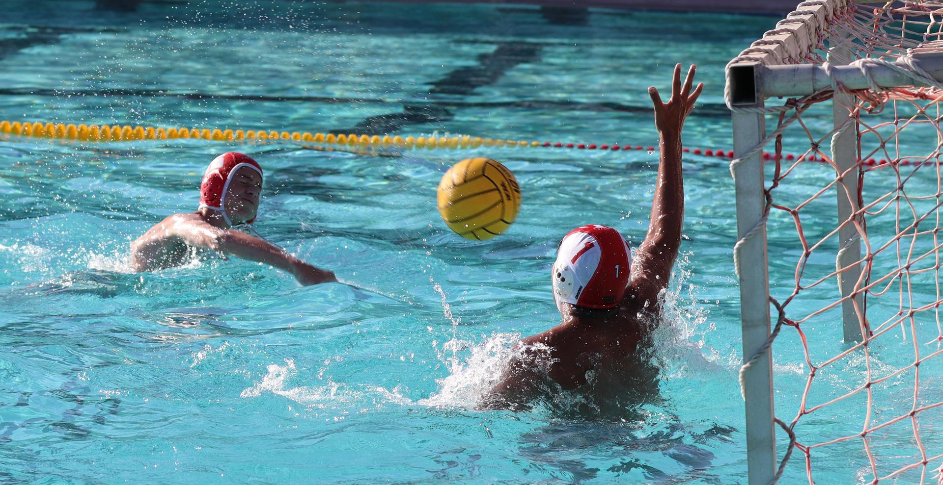 boys water polo players in action against hoover
