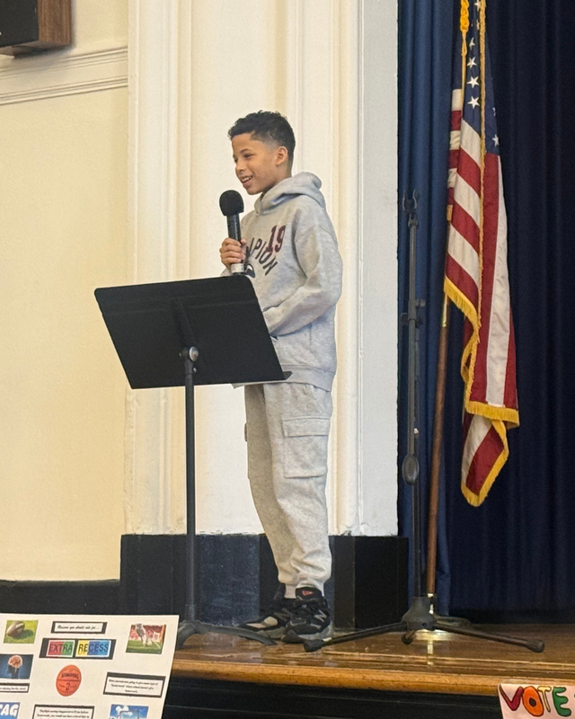 Student is on stage addressing the class