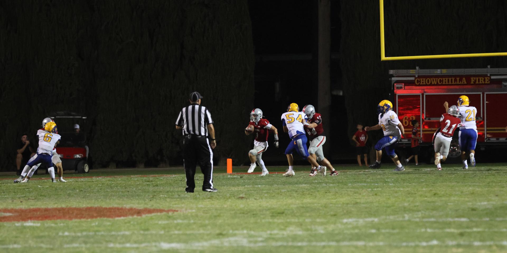 Varsity football players in action against Parlier 38