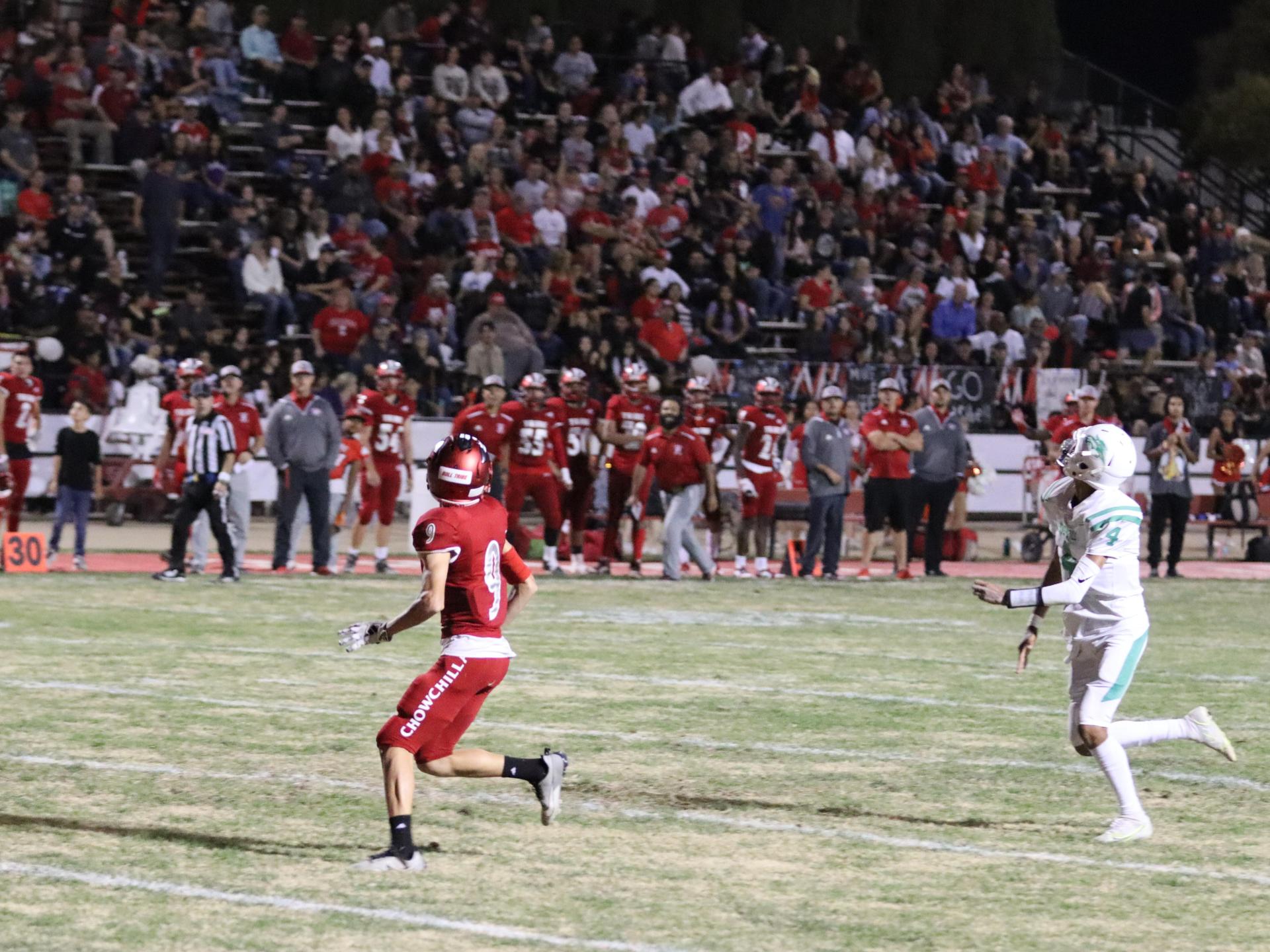 varsity football players in action against Riverdale