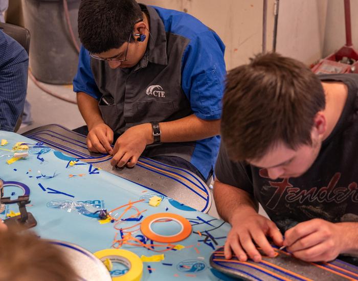 Students design and airbrush skateboards