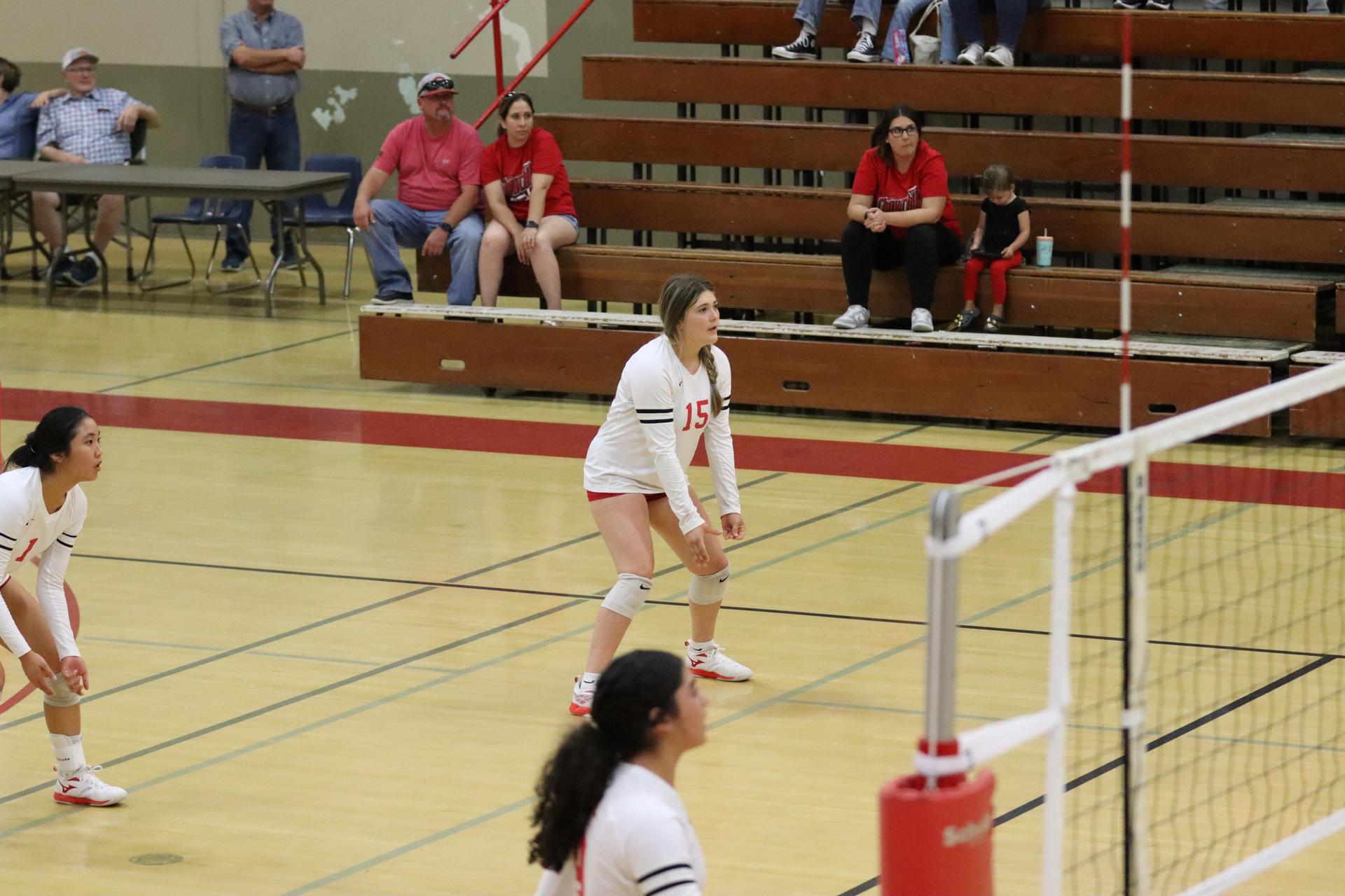 varsity volleyball players in action against liberty
