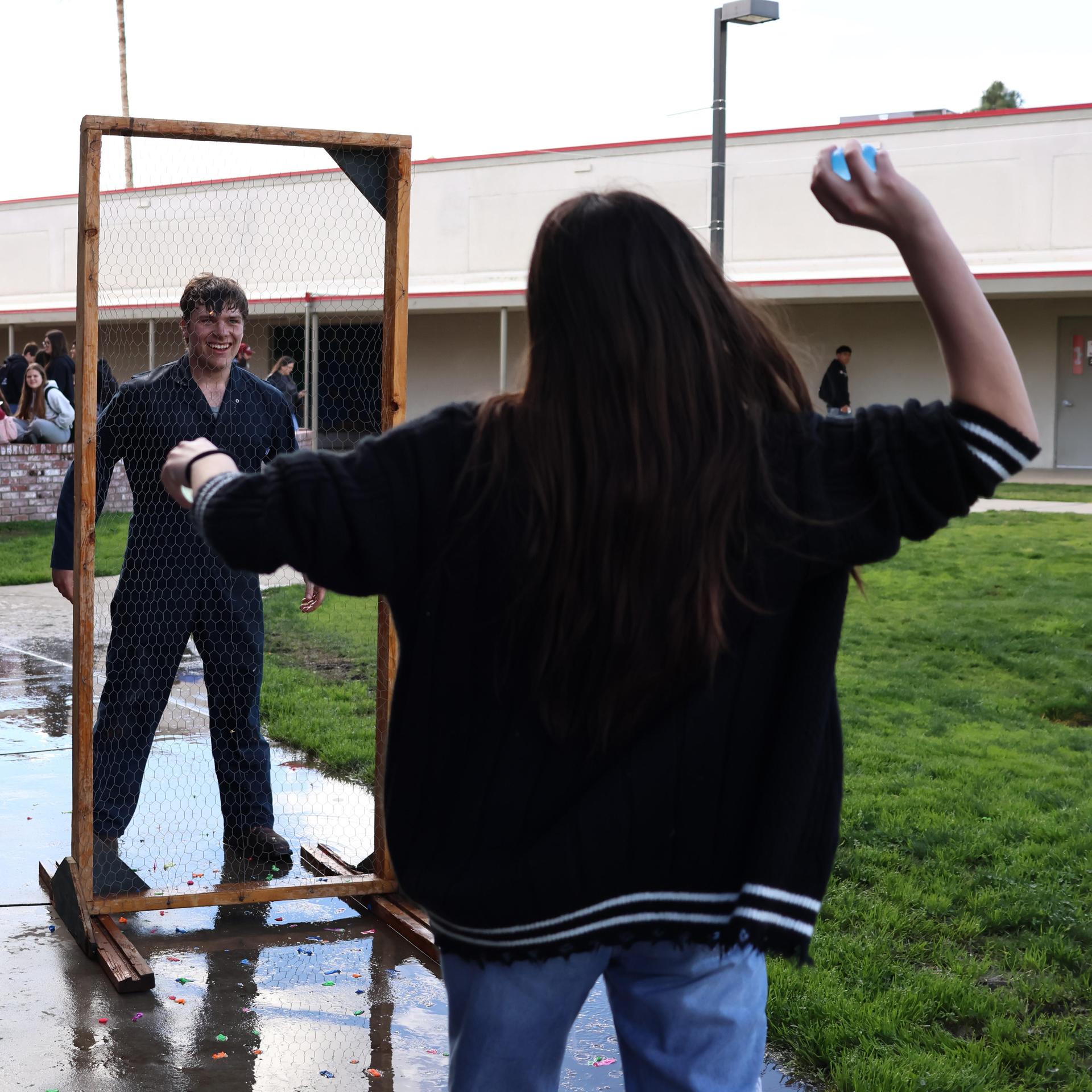 students and staff enjoying the water balloon toss