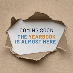Torn paper revealing a message about the upcoming yearbook.