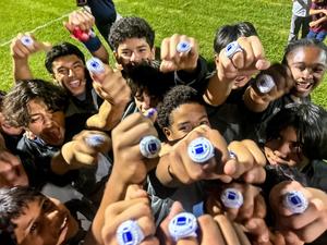 Flag football team celebrates with championship rings