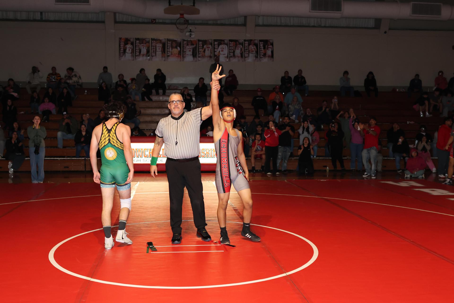 Wrestling winners with hands up 119