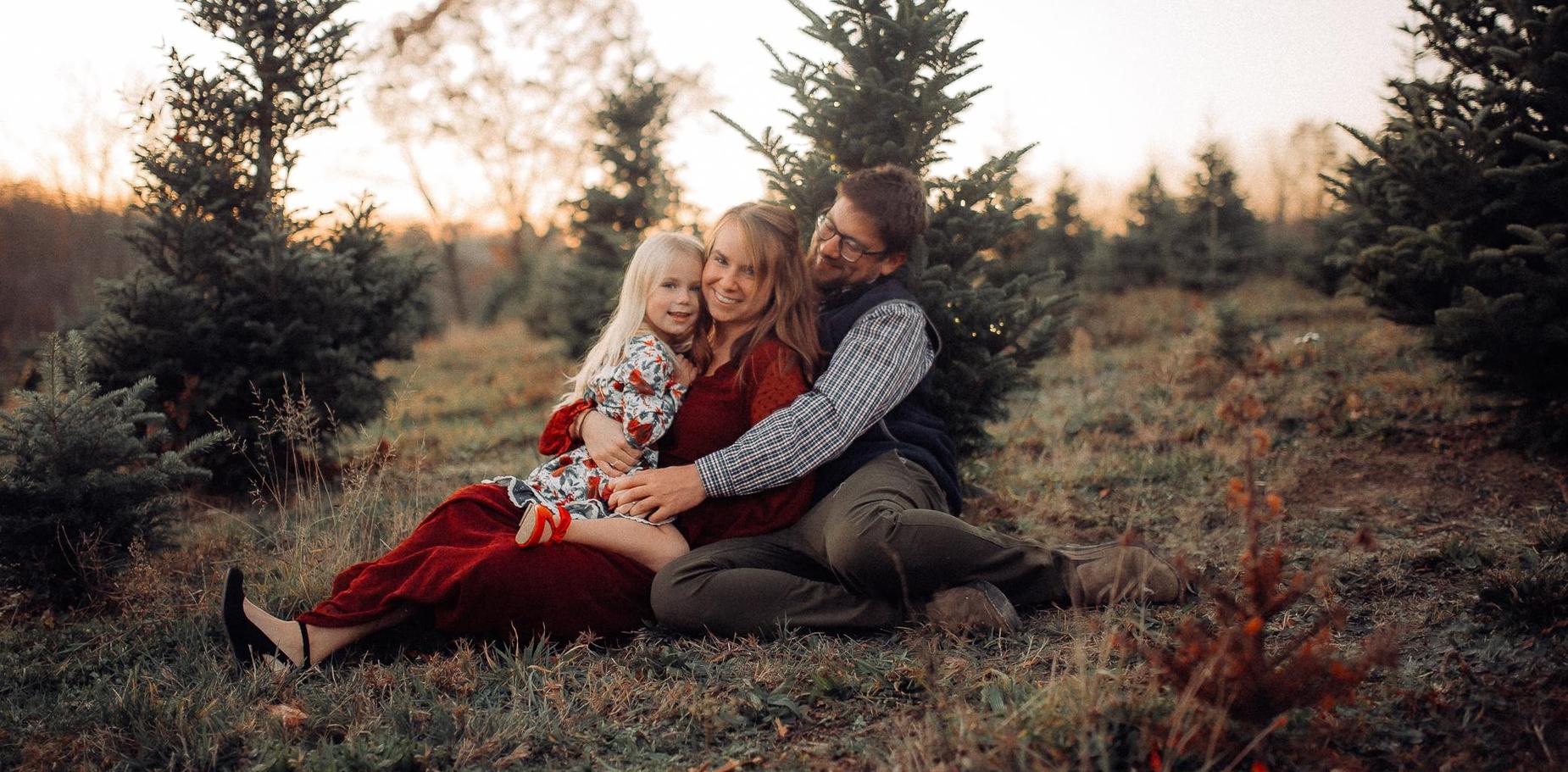 family in a field of trees