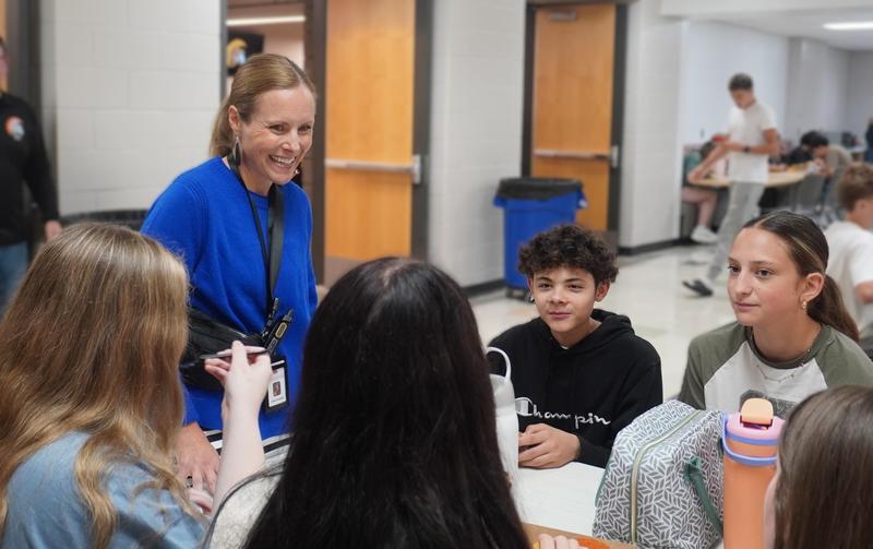 Thornapple Kellogg High School Principal Katie Dorband talks with students at lunch.