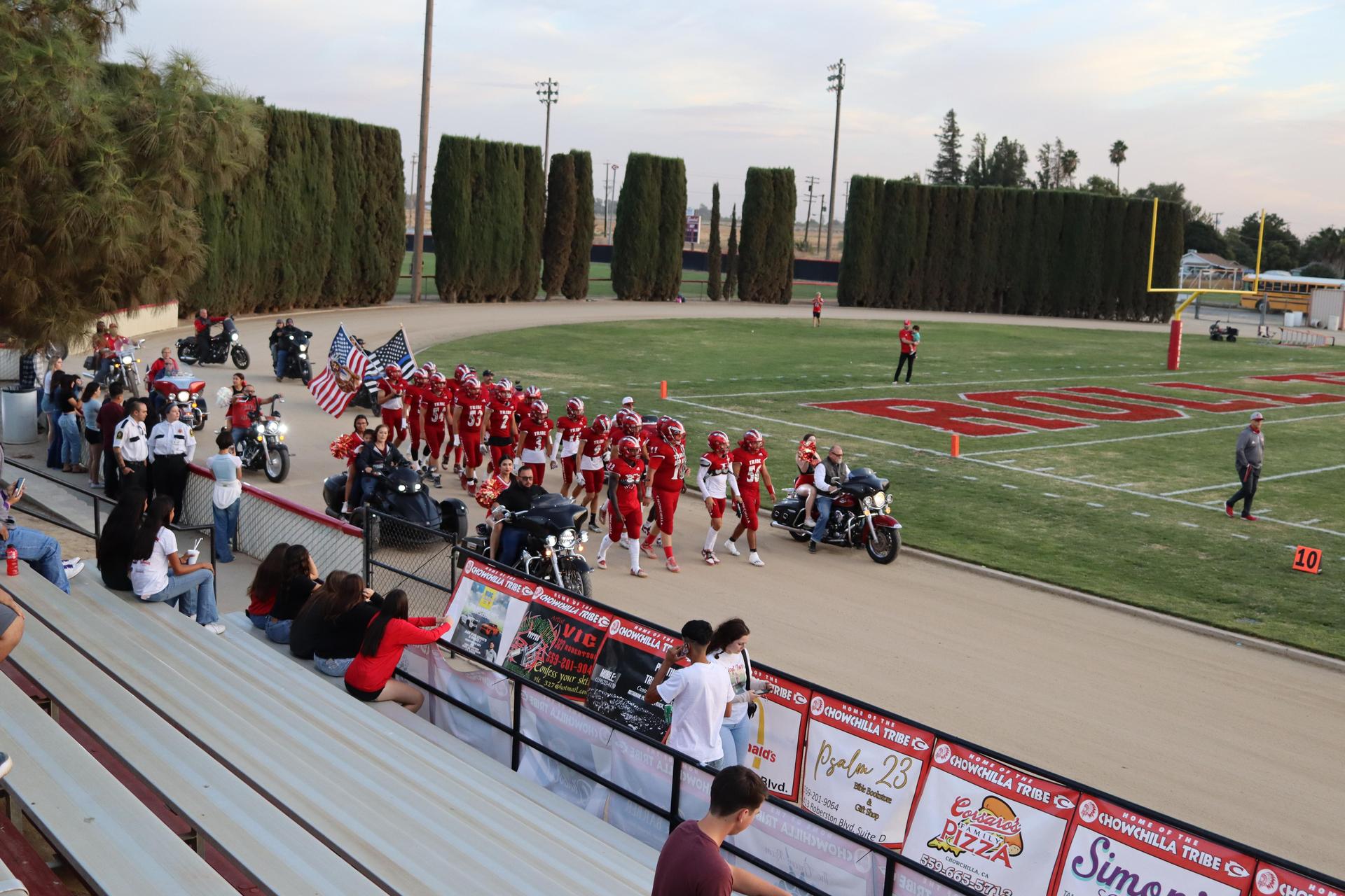 students, staff, and community members enjoying Friday night at the football game