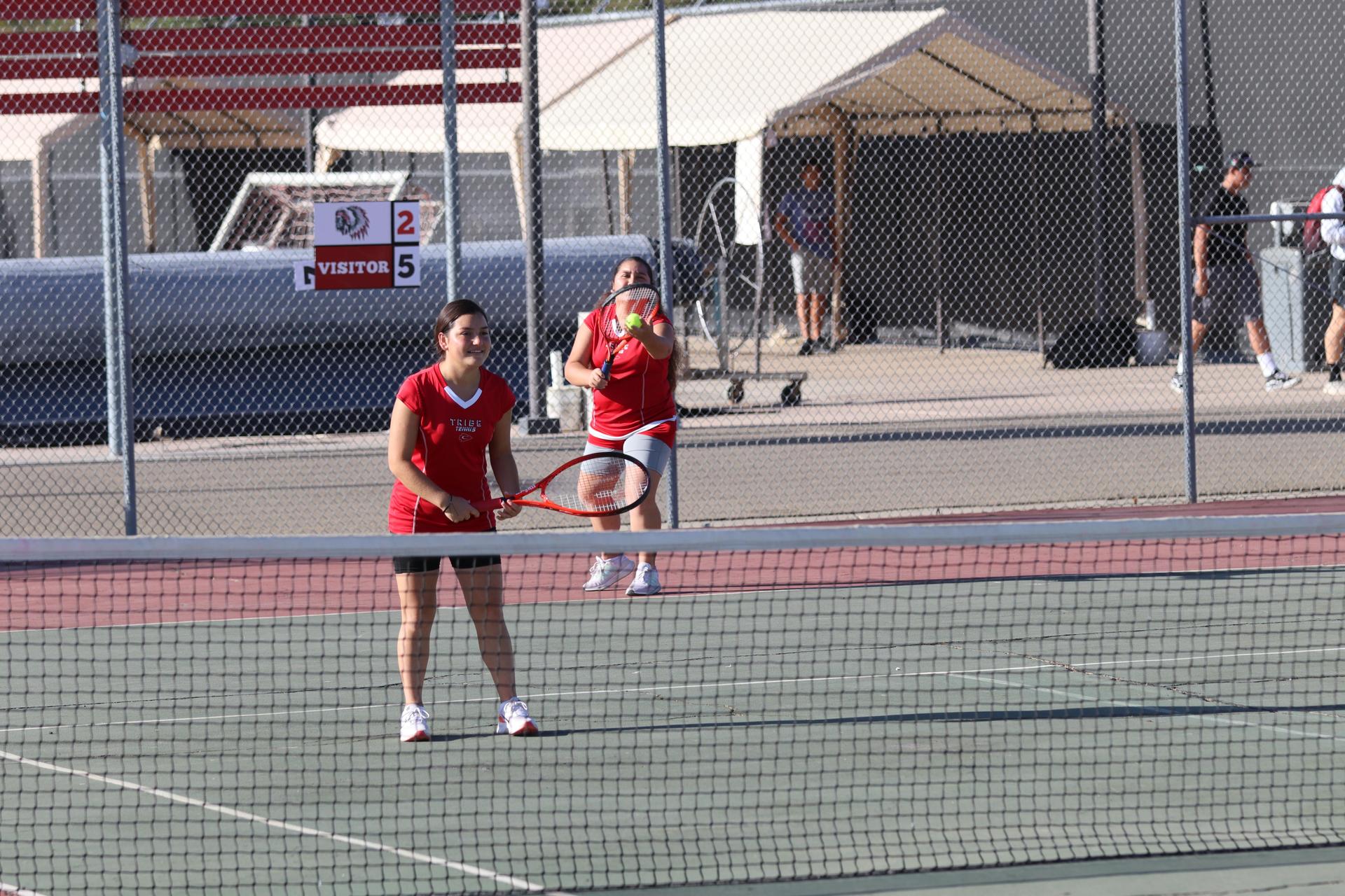 tennis players, family, and staff celebrating senior night