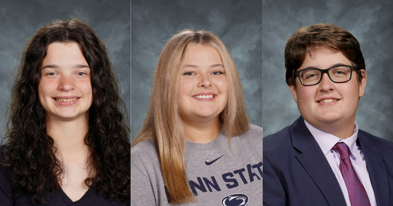 two boys and one girl smiling at camera in school photos