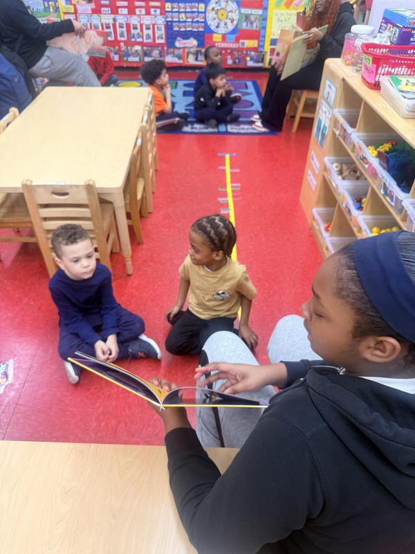 Student reading to others