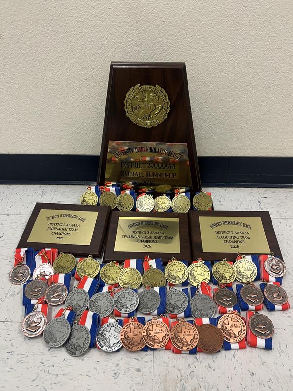 Several medals and trophies from academic UIL competition