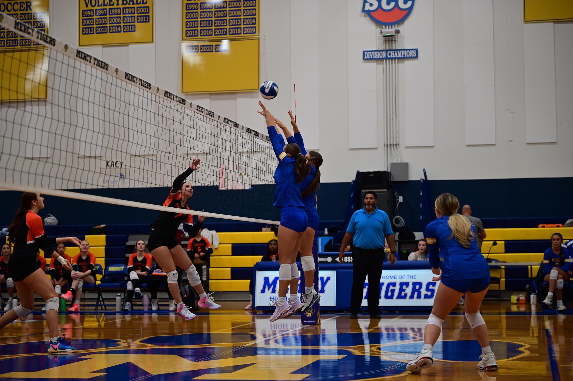 Mercy Volleyball Players Going Up For A Play At The Net