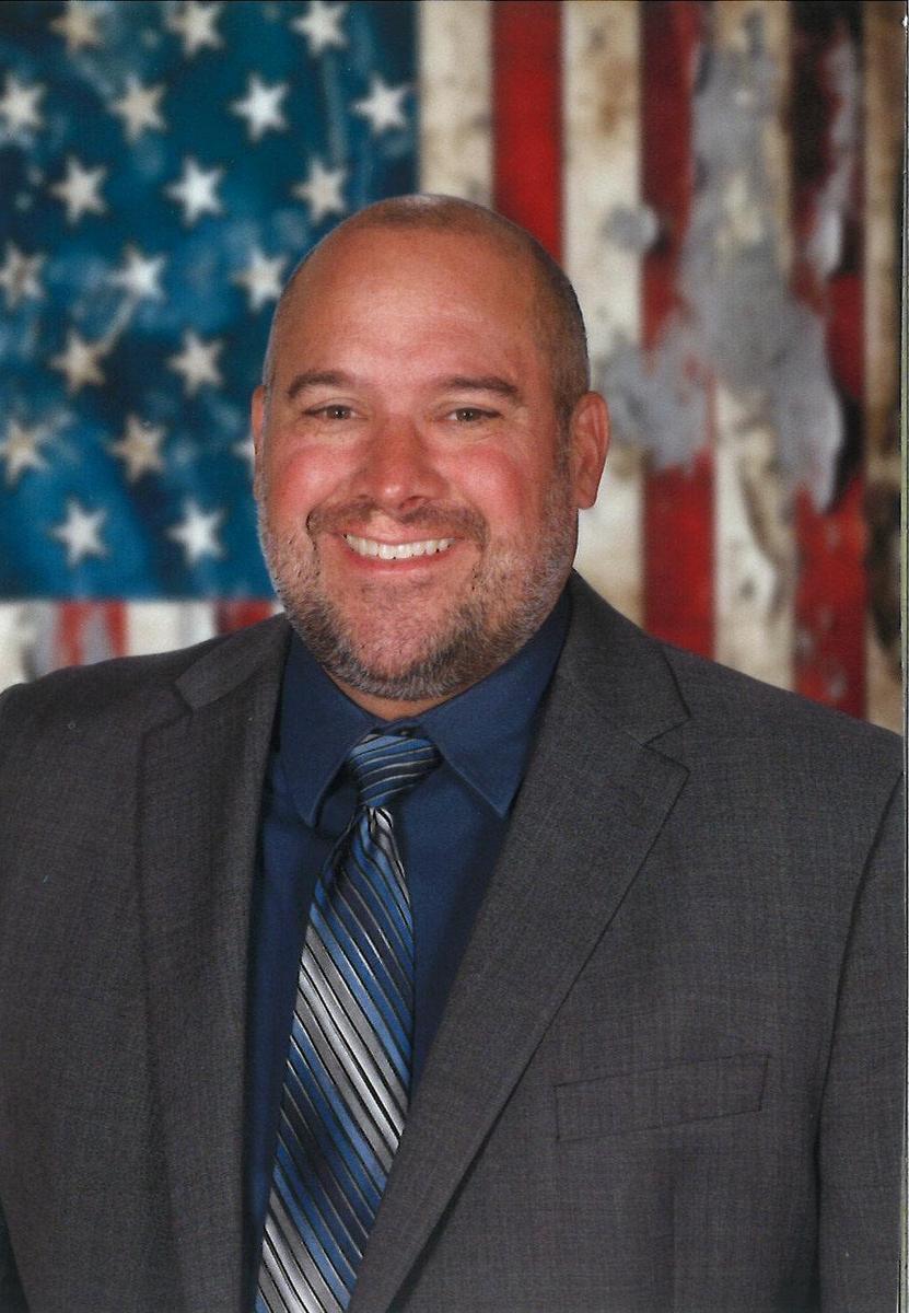 Superintendent Sudvary with American flag background