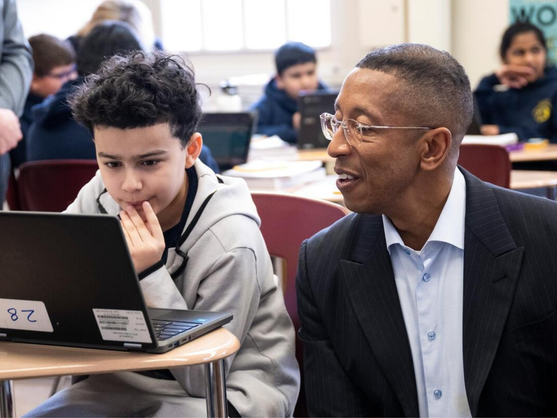 Allan Golston sits down with a student at P.S. 083 .