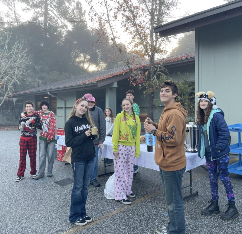 Picture of students standing by a hot cocoa stand