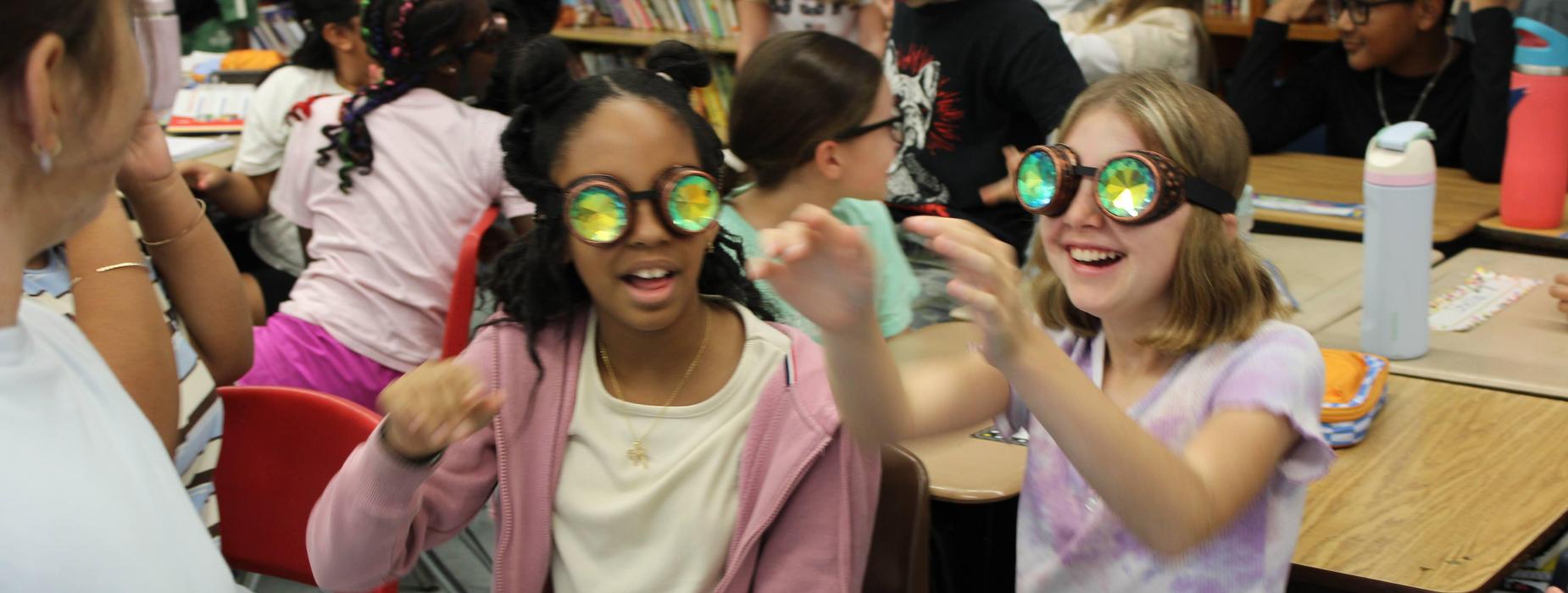 Elementary students experiment with horseshoe crab eye glasses during a presentation from Save the Bay RI.