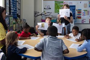 Fifth graders teach kindergarten students how to ride a bus safely