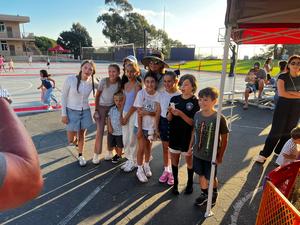 students posing at Family Faith Night in front of petting zoon