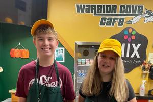 8th-graders Dylan Landram and Brylee Lawson work behind the counter of the snack shop