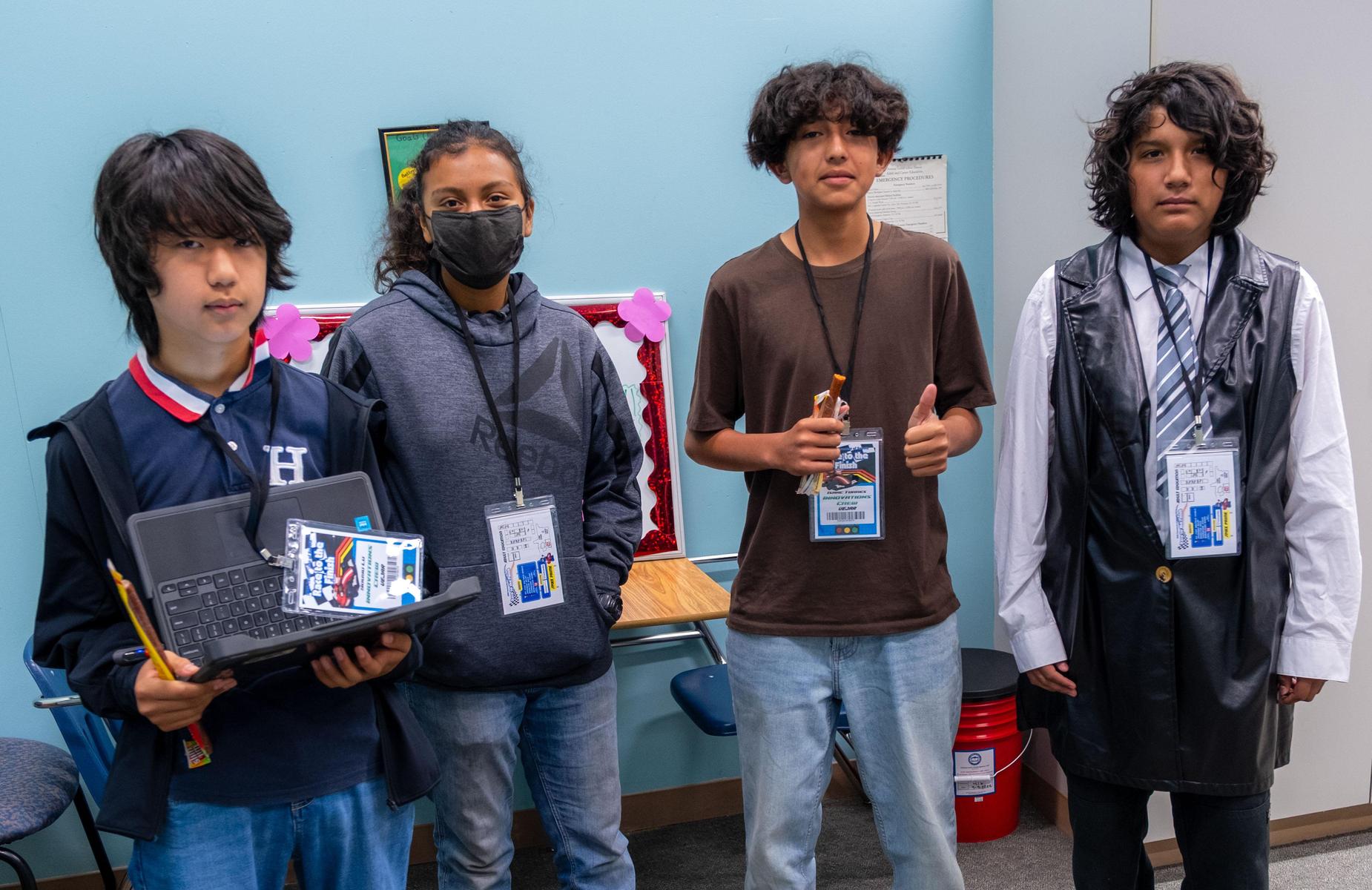 four students in class take brak for photo