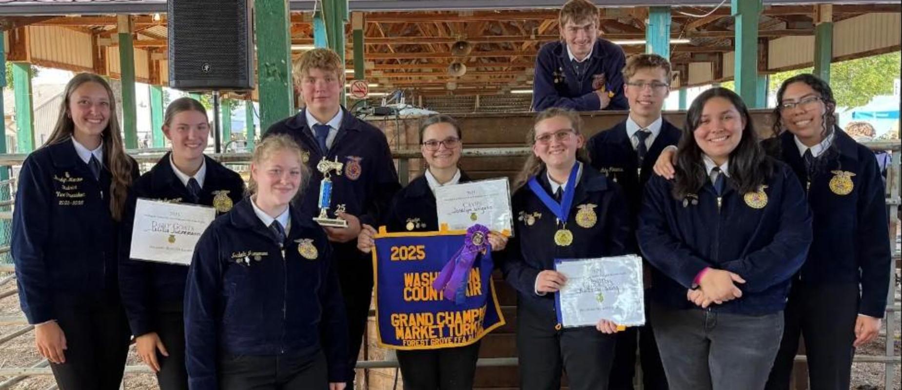 Students posing with awards and certificates at a county fair event.