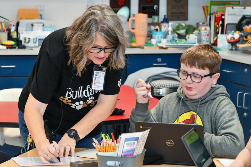 Teacher helping student with a lesson