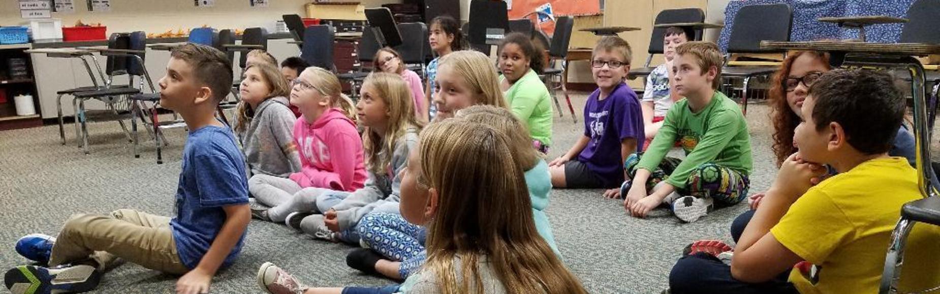 Students sitting on the floor picture