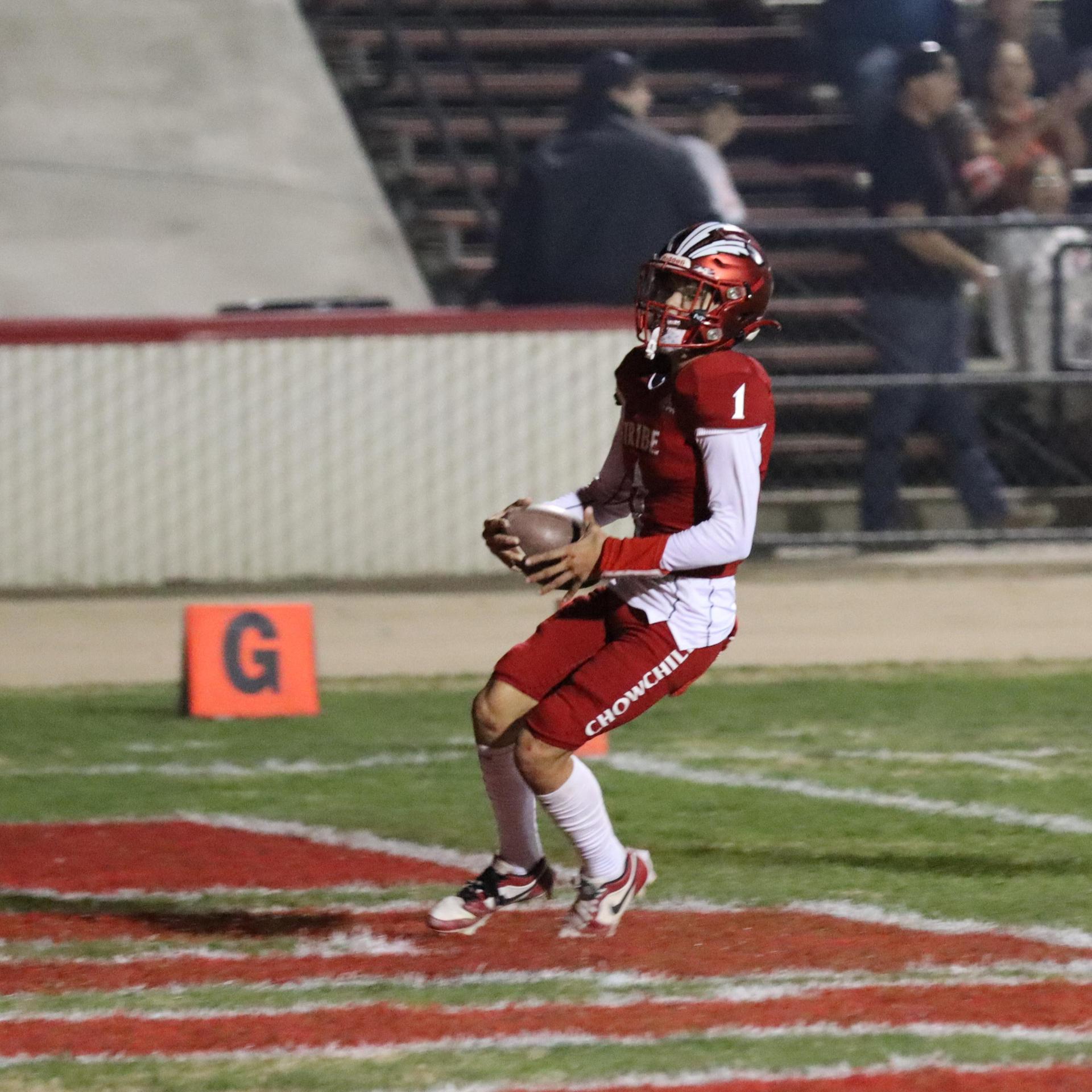 varsity football players in action against Riverdale