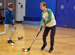 Two people holding hockey sticks