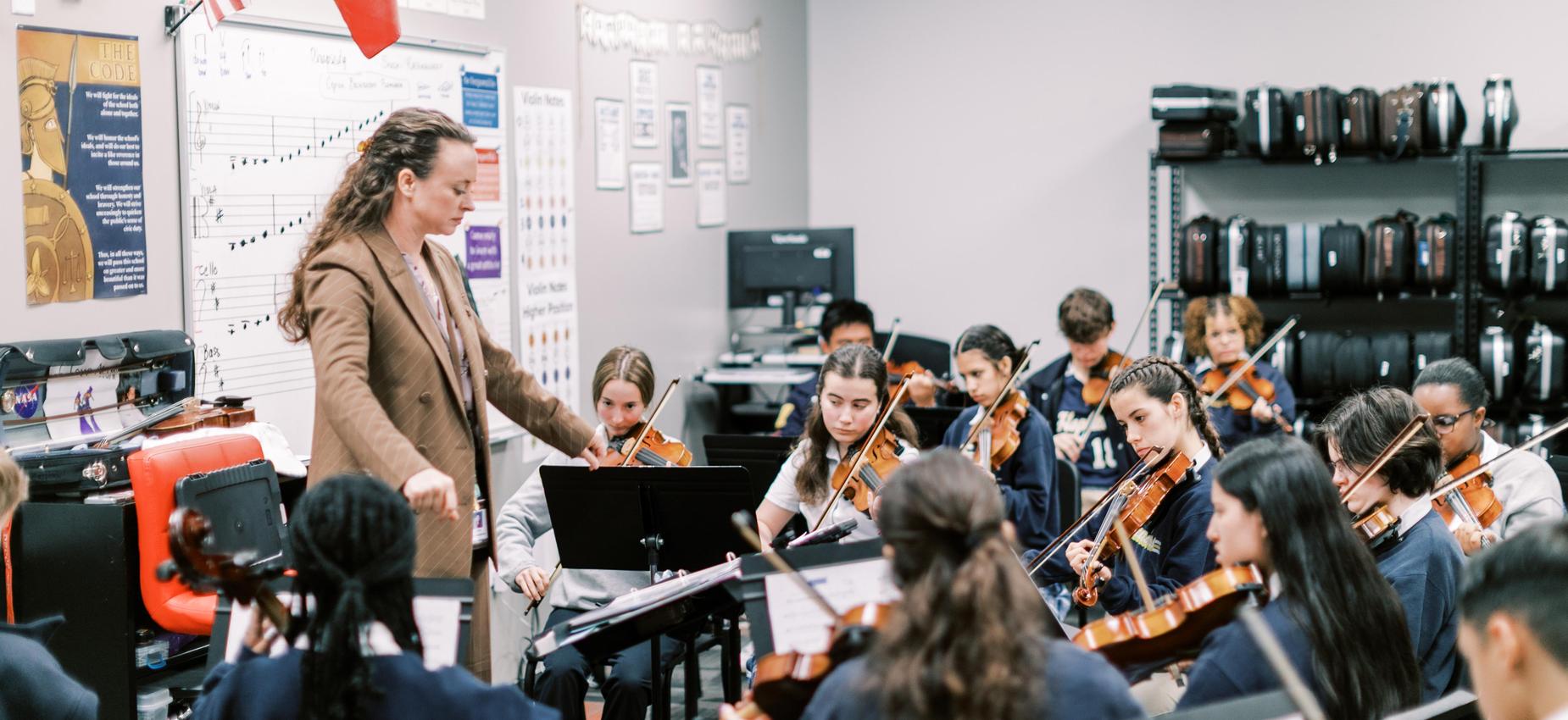 Teacher and students playing instruments