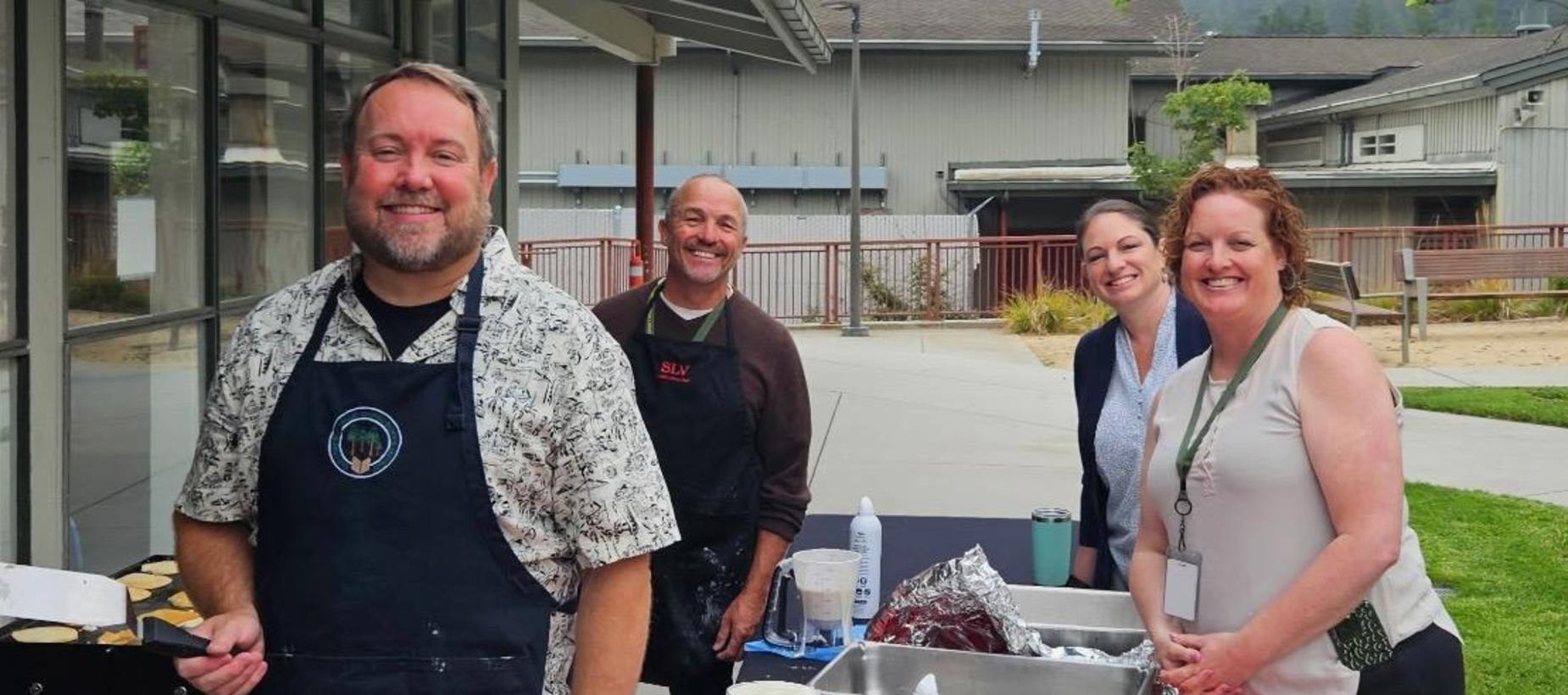 Superintendent and staff flipping pancakes at the 2026 Welcome Back Breakfast.