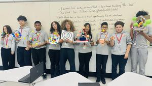 students holding up their atom projects