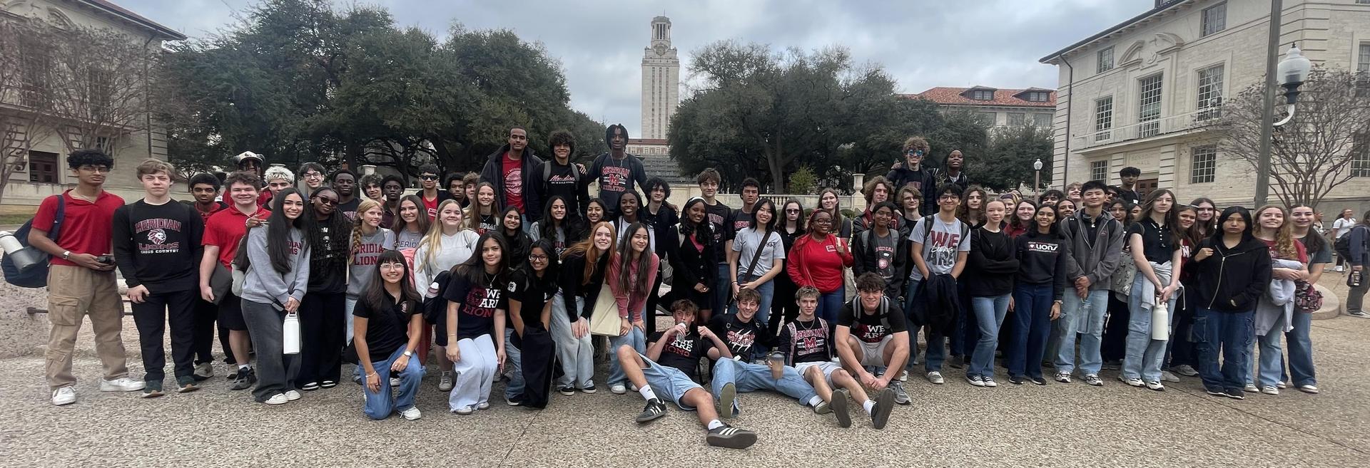 11th graders stand in front of the University of Texas tower and clock