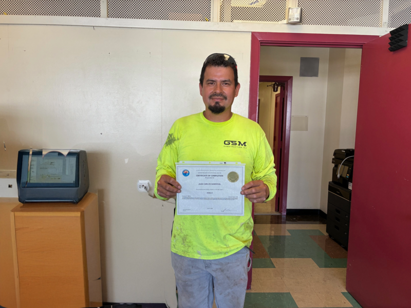 Juan's Photo holding certificate