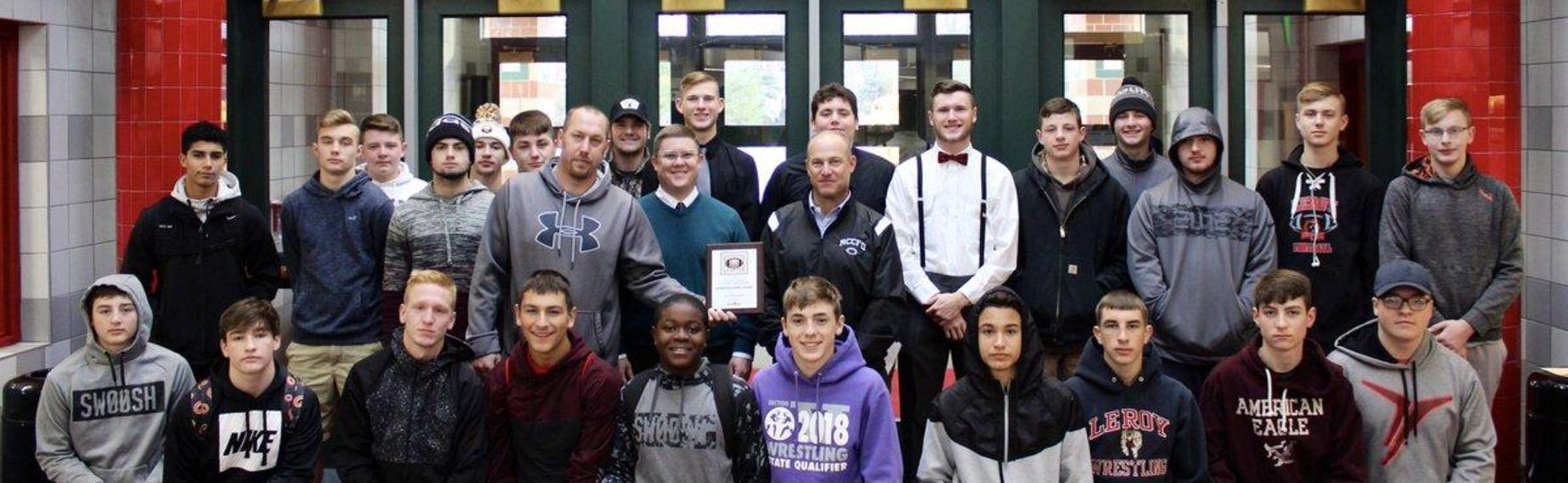 Varsity Football team accepting sportsmanship award