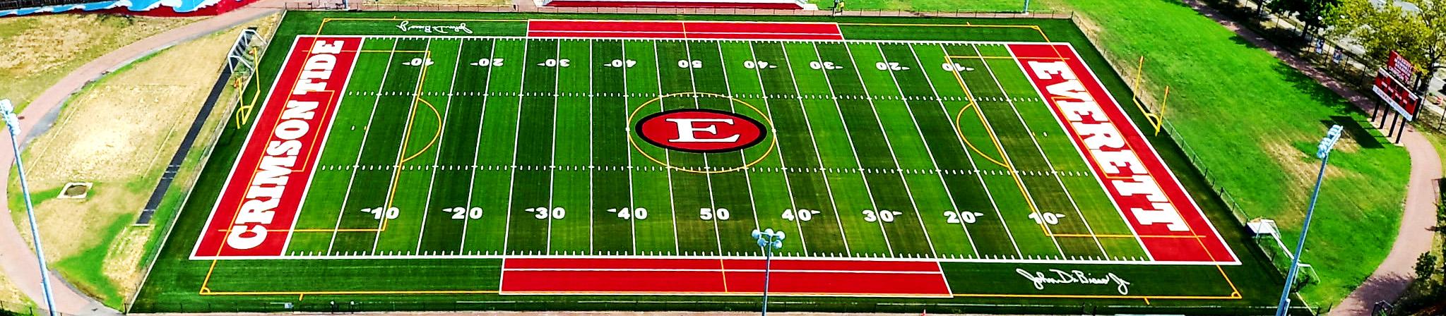 Aerial view of a sports field with markings and 'Crimson Tide' and 'Everett' text.