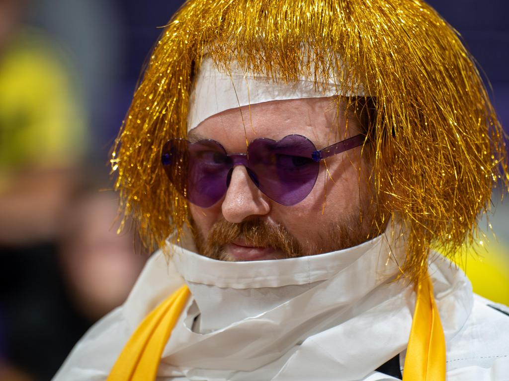 A faculty member wearing a gold wig and purple heart sunglasses.