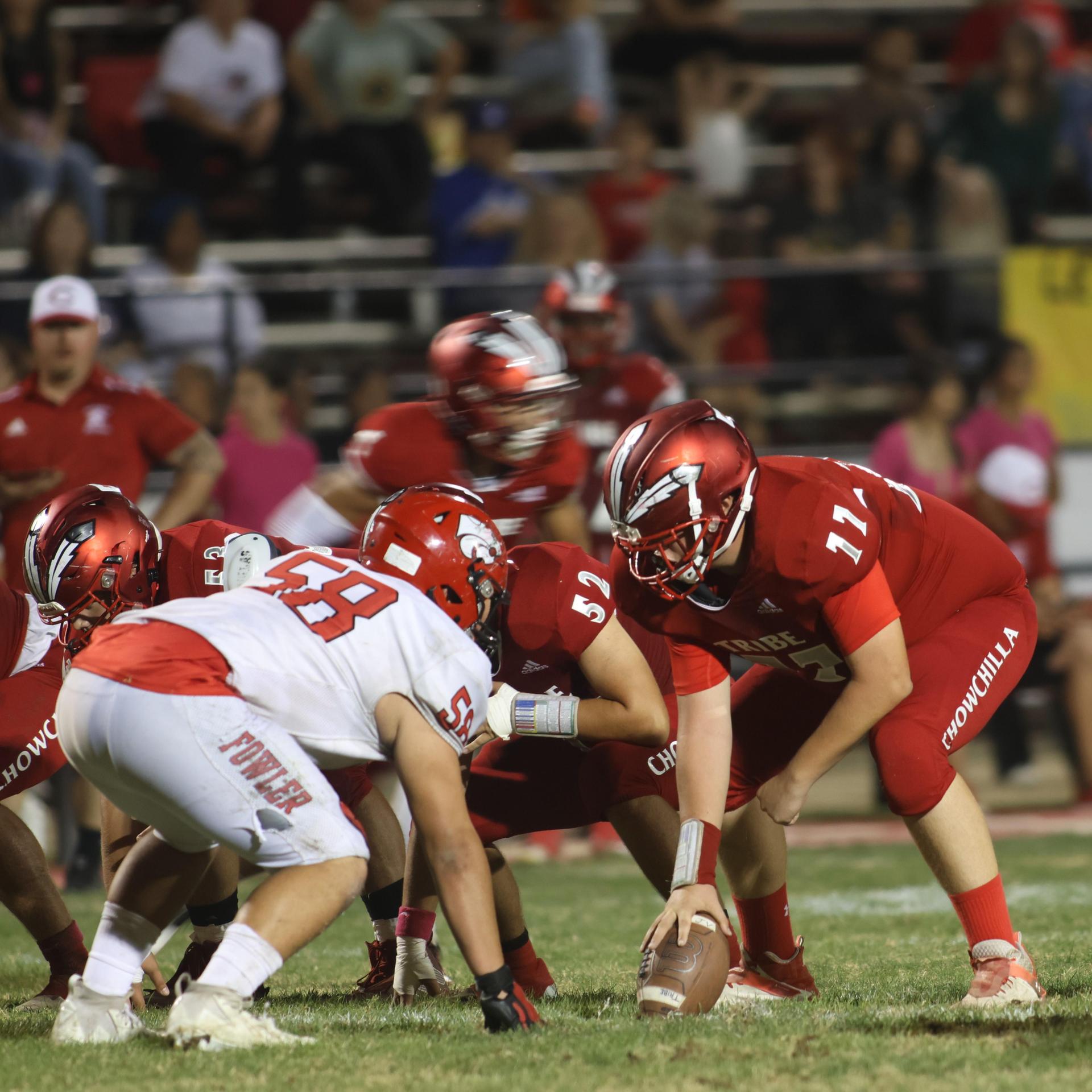 varsity boys playing football against Fowler