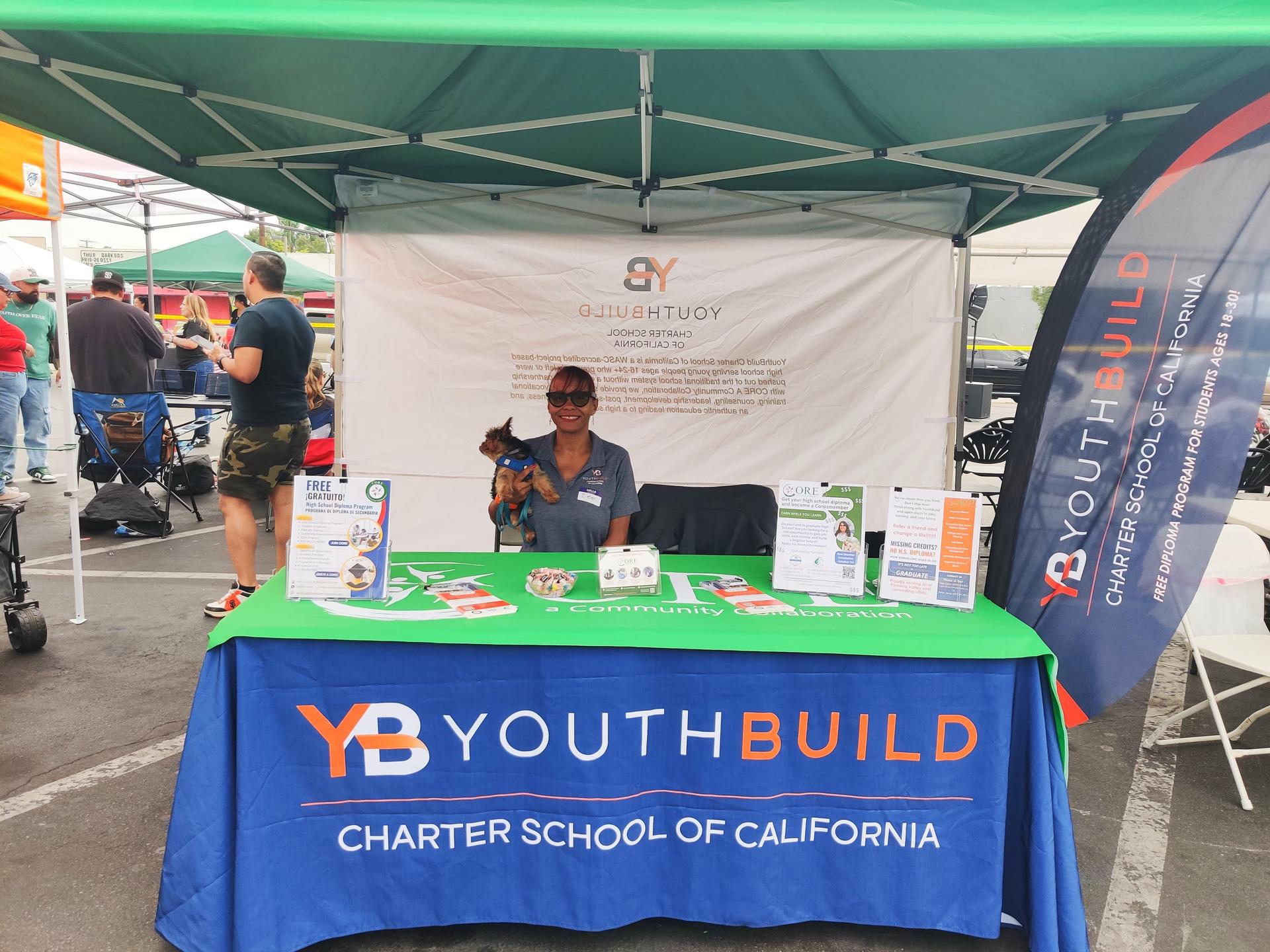 Dee and her dog tabling in the community